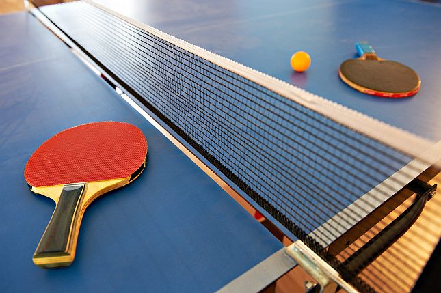 Table tennis rackets and orange ball